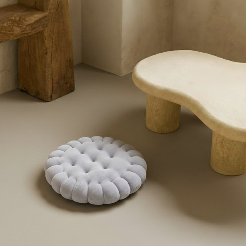 Round Grey Floor Cushion on a beige floor with a wooden stool in the background