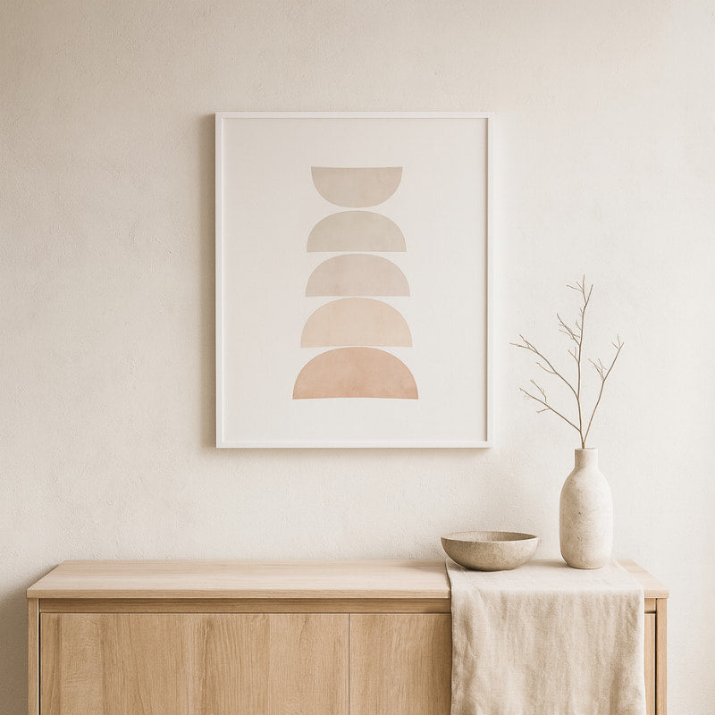 Abstract poster art on a wall above a wooden cabinet with decorative items.