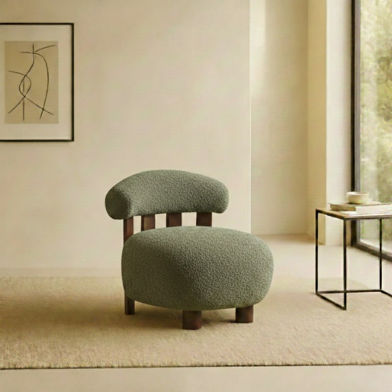 Green textured accent chair japandi with a abstract painting on the wall and a table by a window.