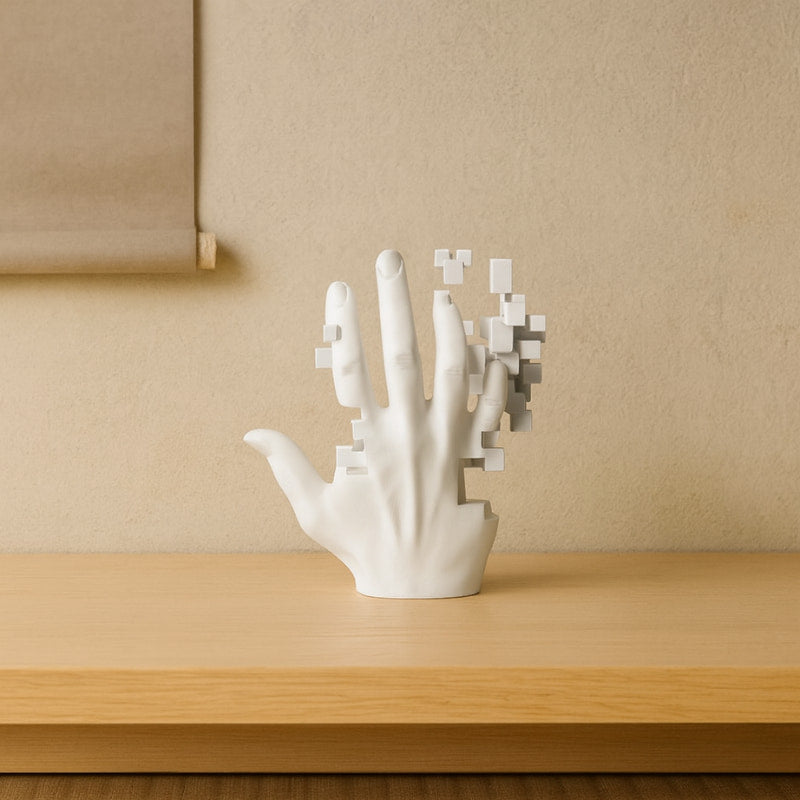 White art deco hand shaped sculpture on a wooden surface with a beige wall background