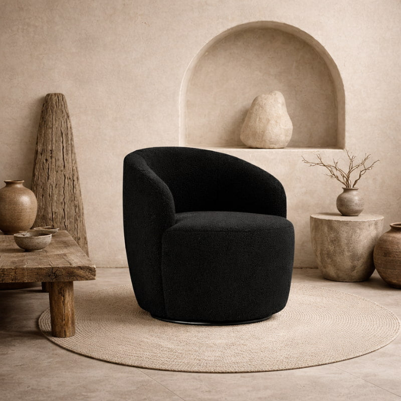 Black boucle swivel lounge chair in a room with neutral tones and rustic elements