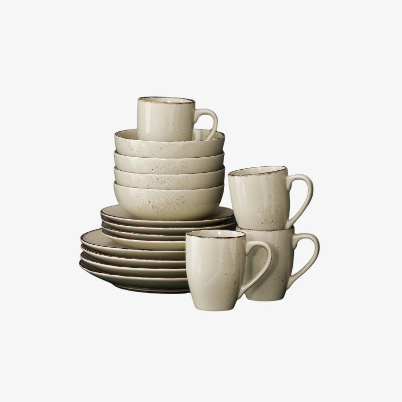 ceramic dining table set including mugs and bowls on a white background