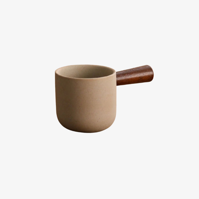 Ceramic coffee mug with wooden handle on a white background
