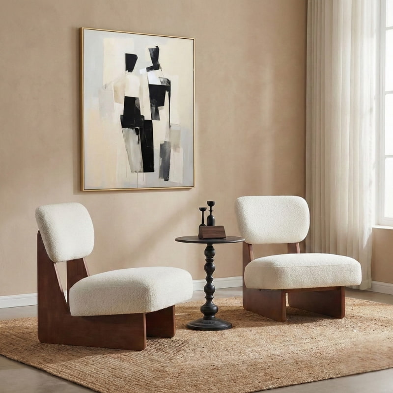 contemporary upholstered minimalist accent chair white, a small round table, and abstract art on the wall.