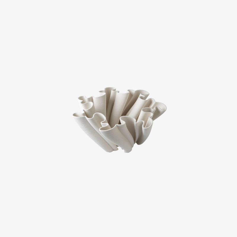 White decorative ceramic vases with a unique design on a white background