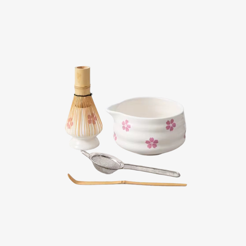 Tea-making set with a design ceramics bowl, whisk, and spoon on a white background