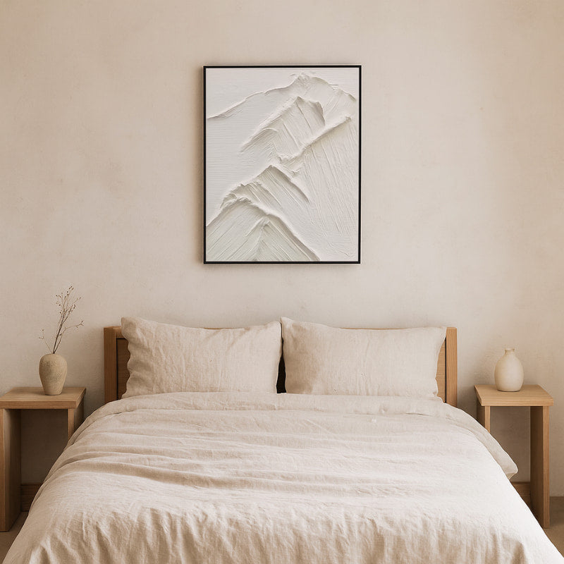 Beige bedroom with a bed, nightstands, and a interior design white paint piece on the wall.