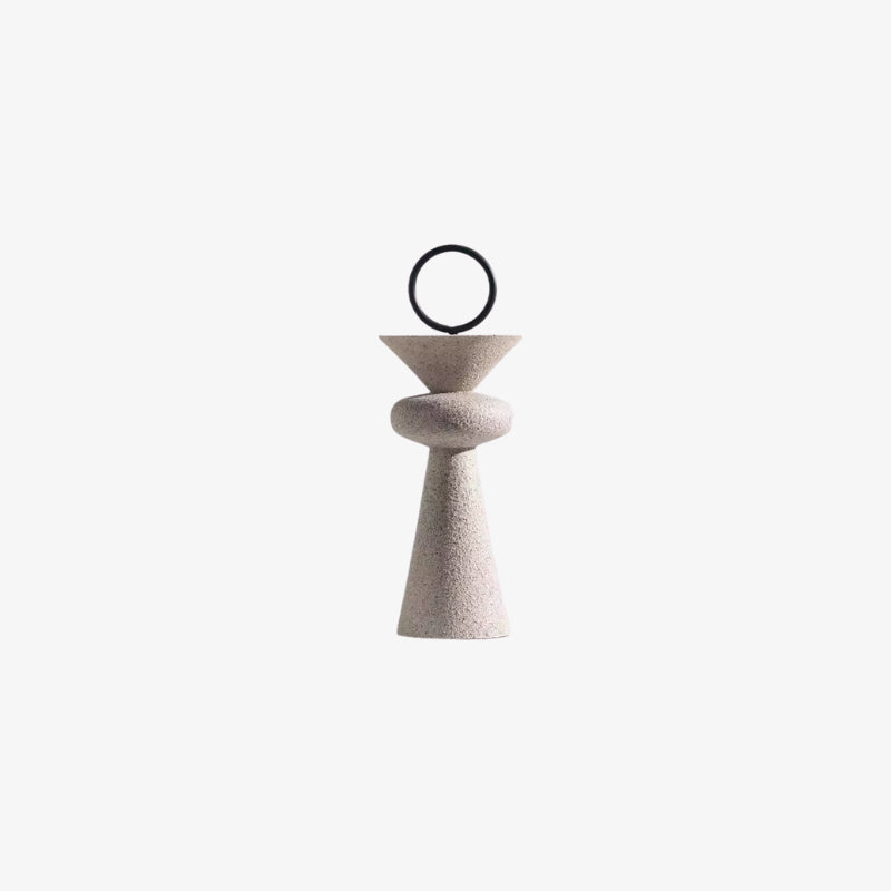 iron and resin object with a cylindrical base and circular top on a white background