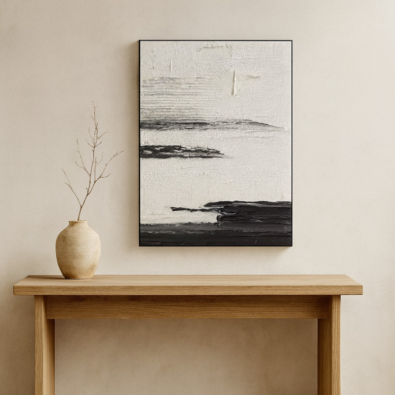 Japanese art wabi sabi on a beige wall above a wooden console table with a vase.