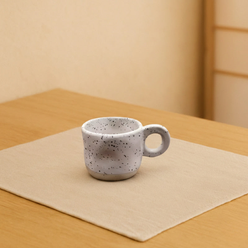 japanese tea cup ceramic on a table in a wabi sabi room.