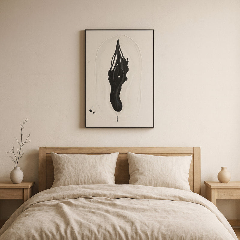 Bedroom with wooden bed, beige bedding, and japanese wabi sabi art on the wall.