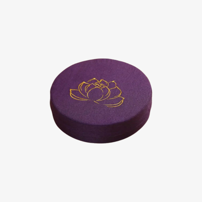 large purple floor cushions with a gold lotus flower design on a white background