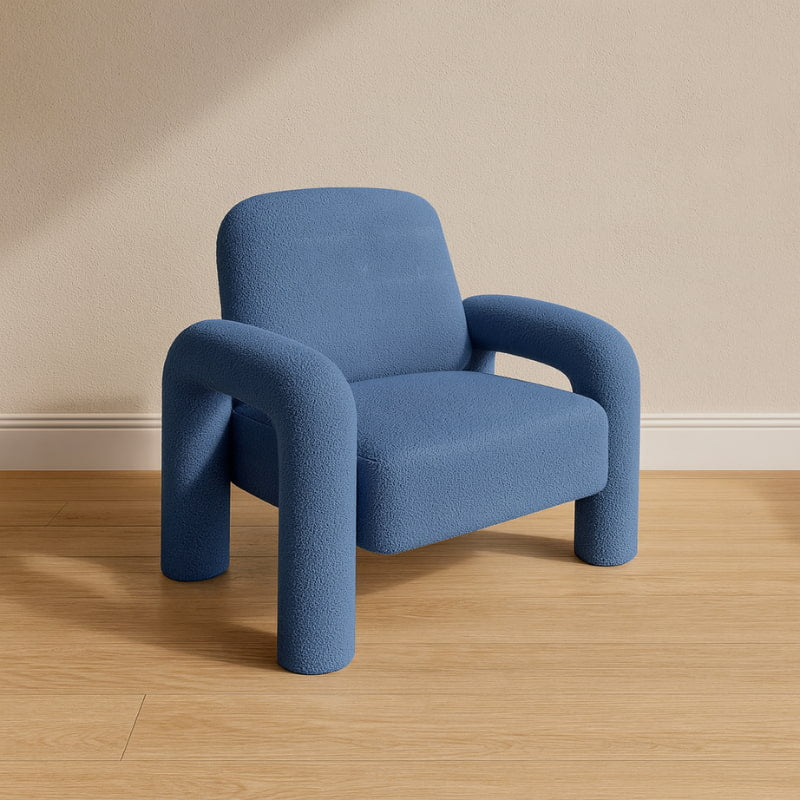 Light Blue fluffy chair on a wooden floor with a beige wall background