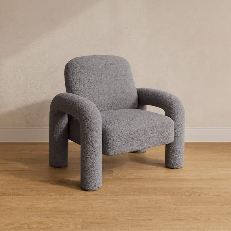 light grey chair fluffy chair on a wooden floor with a beige wall background