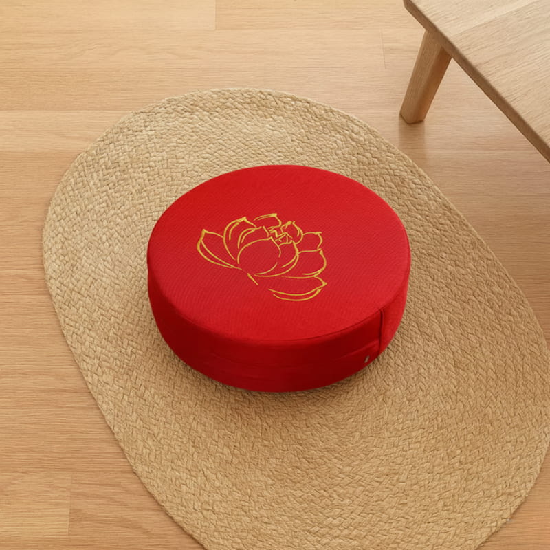 lotus flower cushion on a rug with a wooden table on the side.
