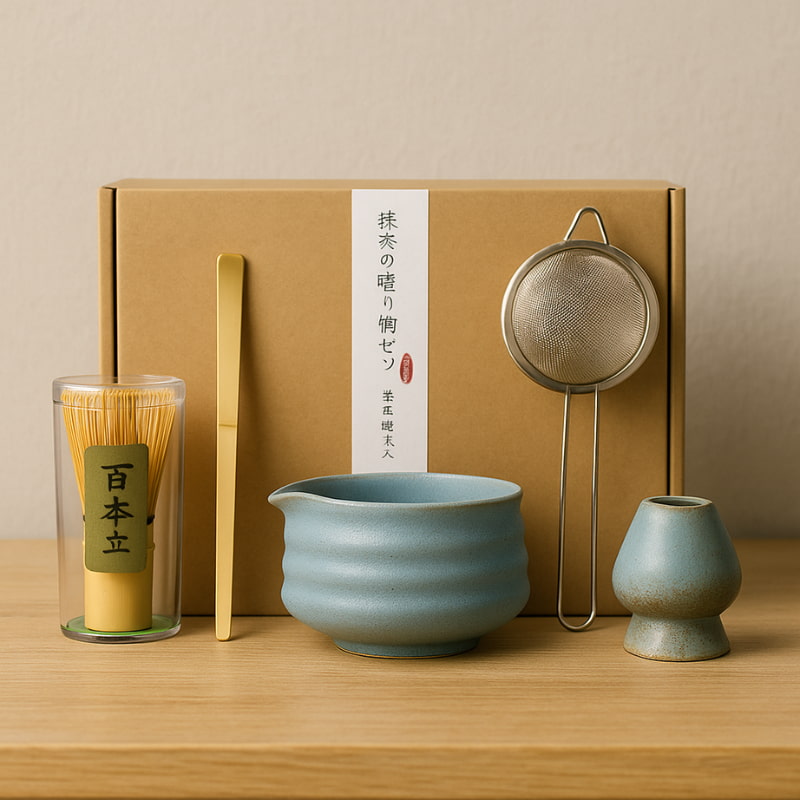 Tea matcha design set with a blue ceramic bowl, glass container, and other accessories on a wooden surface.
