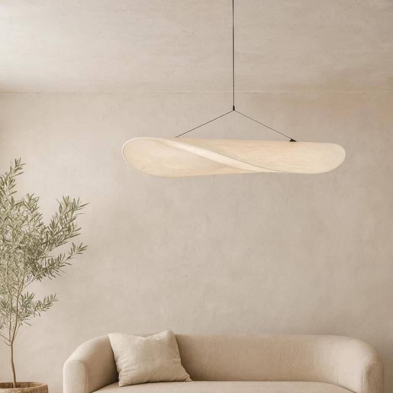 Modern ceiling led lights hanging above a beige sofa with a plant in the corner against a beige wall.