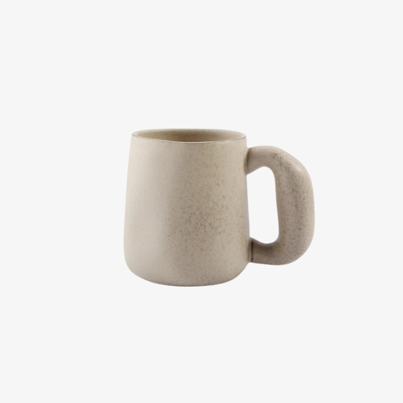 Beige pottery handmade mugs on a white background