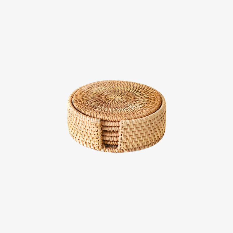 Rattan coaster set in a round basket on a white background