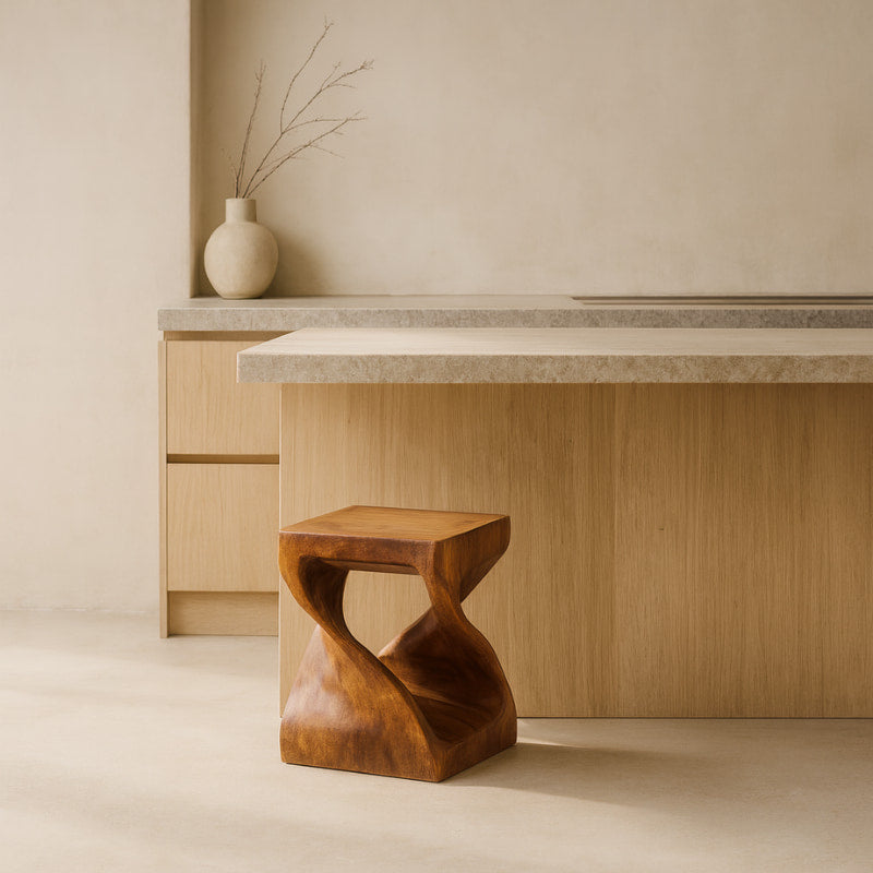 Wooden small stool in front of a wooden desk with a vase on a shelf in a minimalistic room.