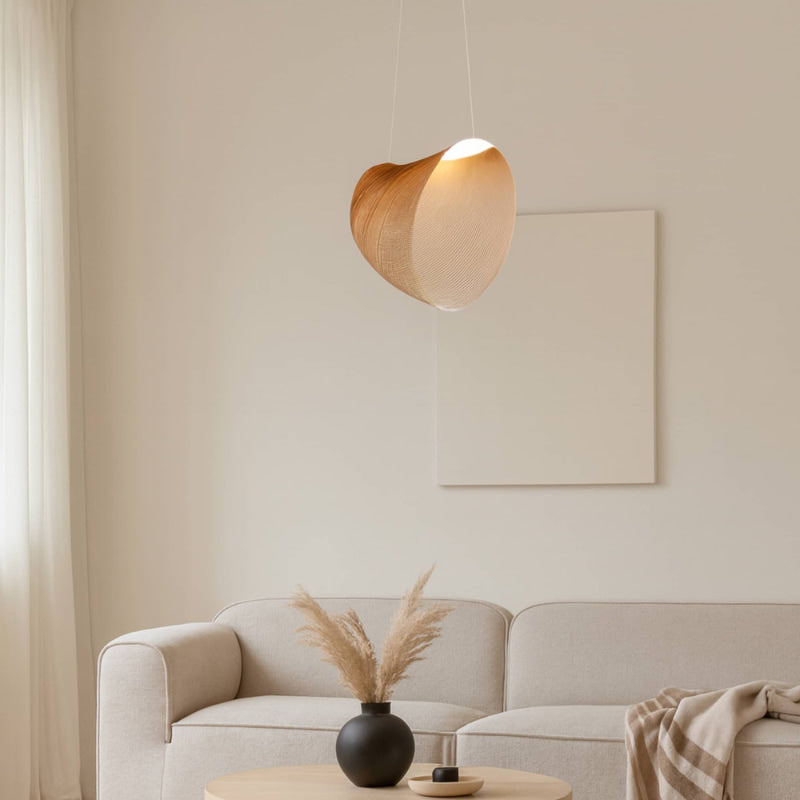 Modern living room with a beige sofa, small wabi sabi chandelier, and decorative elements.