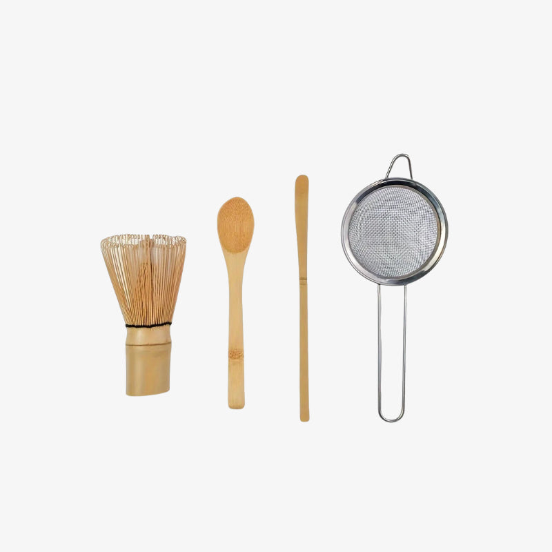 teatox matcha ceremony set tools including a whisk, spoon, and strainer on a white background