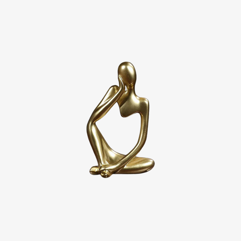Gold thinking man statue on a white background