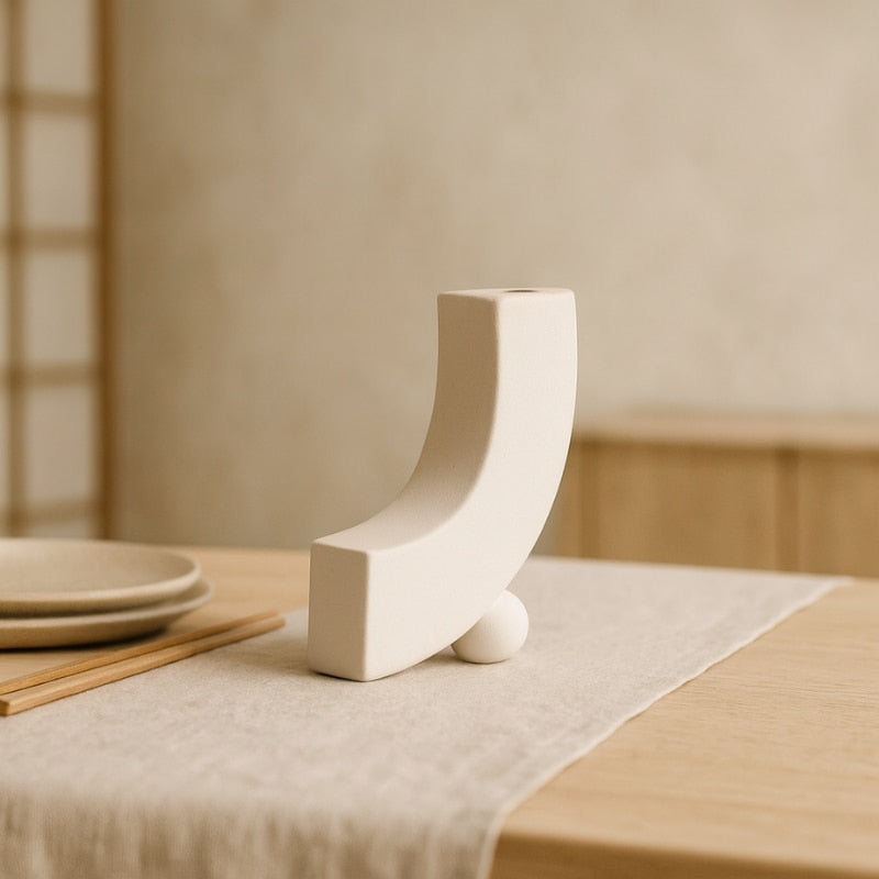 Unique designer vase on a wooden table with a neutral background