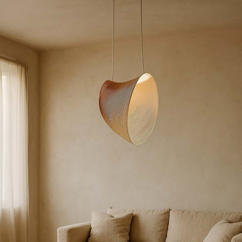 Modern wabi sabi chandelier hanging above a beige sofa in a room with neutral walls.