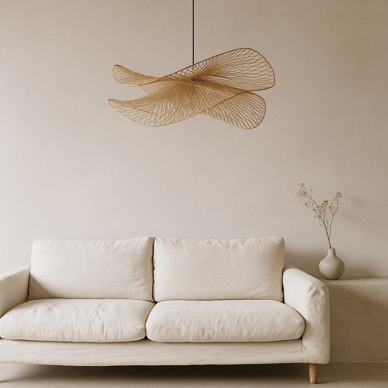Beige sofa with a decorative wabi sabi lighting and vase in a minimalistic room.