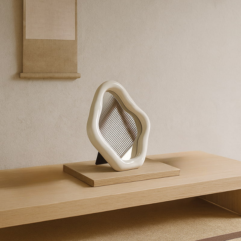 wabi sabi mirror on a wooden surface with a minimalistic background