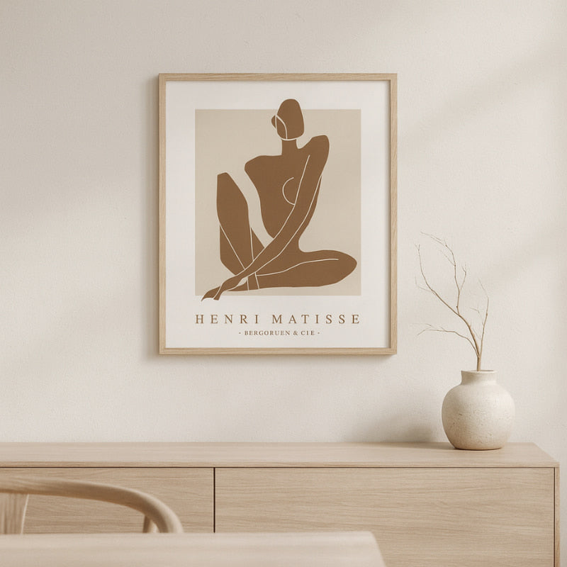 wabi sabi print artwork on a wall above a wooden cabinet.