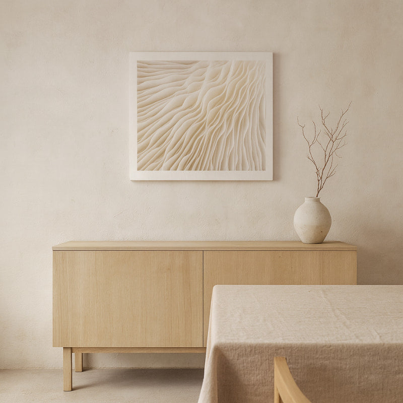 Beige sideboard with a vase and wabi sabi wave art in a minimalistic room.