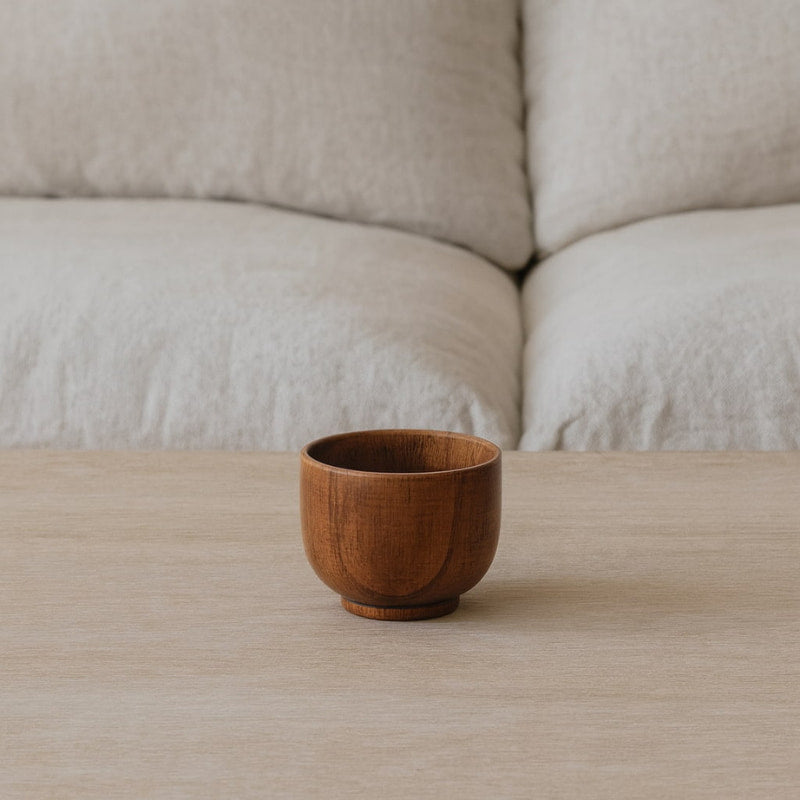 Wabi sabi wood cup on a wooden surface with a neutral background