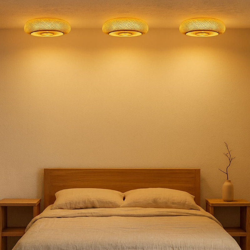 Bedroom with wooden headboard, nightstands, and warm wall lights.