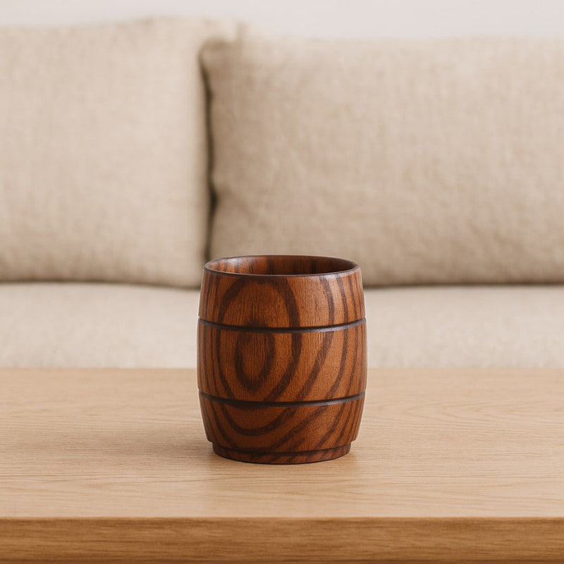 wood coffee mug on a wooden table with a beige sofa in the background