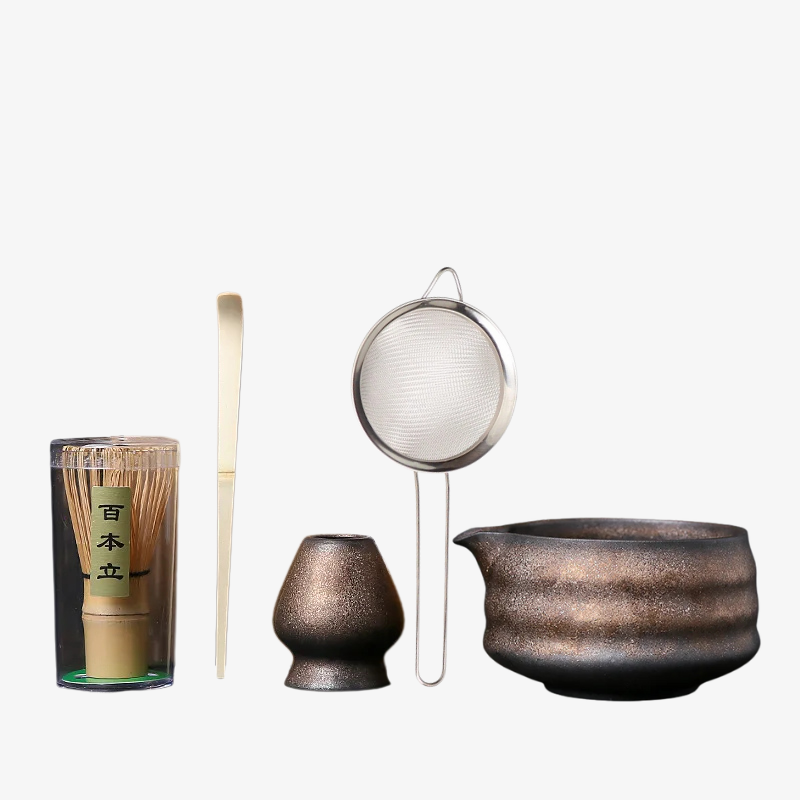 Zens matcha set Japanese tea-making tools including a glass container, whisk, spoon, and large pot on a white background.