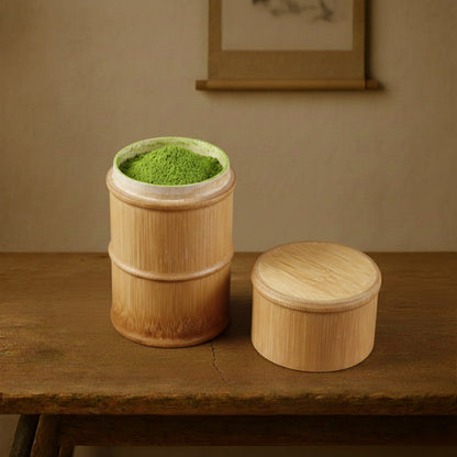 Bamboo Tea Box with green powder on a wooden table