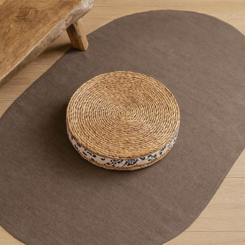 Round Handmade Floor Cushions on a brown mat with wooden furniture in the background