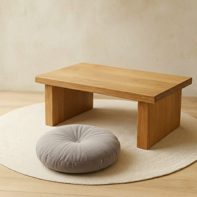 Wooden low table with a round gray Japanese Floor Cushion​ on a beige rug
