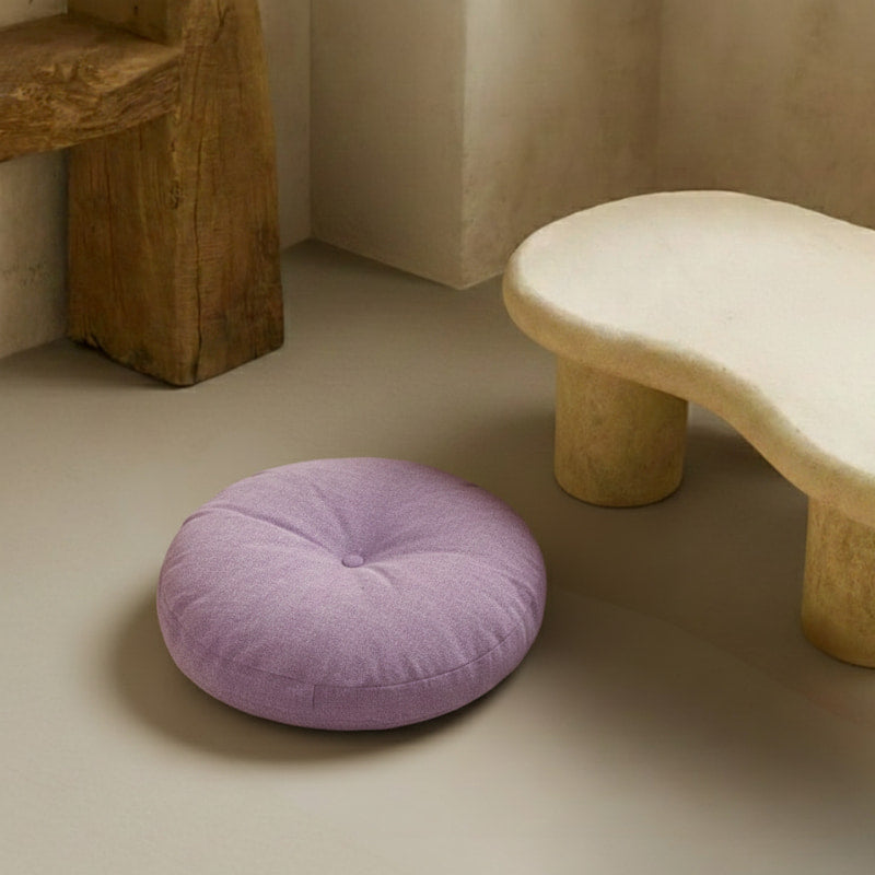 Purple Japanese Seating Cushion on a beige floor next to a wooden stool.