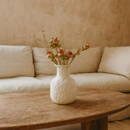 Vase Wabi Sabi Style with dried flowers on a wooden table in a living room setting