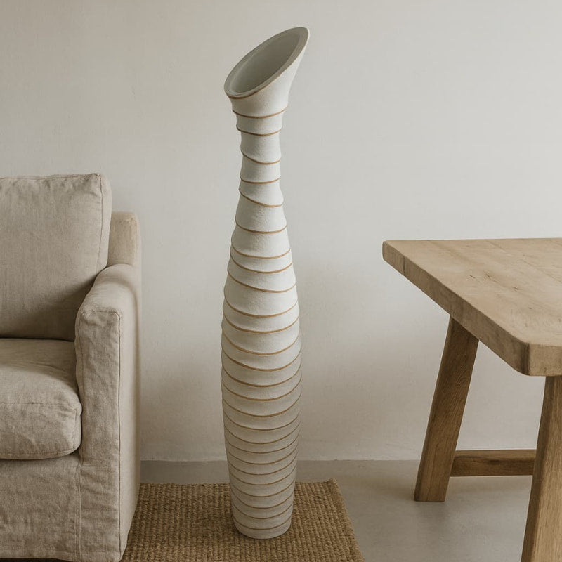 Tall Wabi Sabi Floor Vase in a minimalistic room with a beige sofa and wooden table.