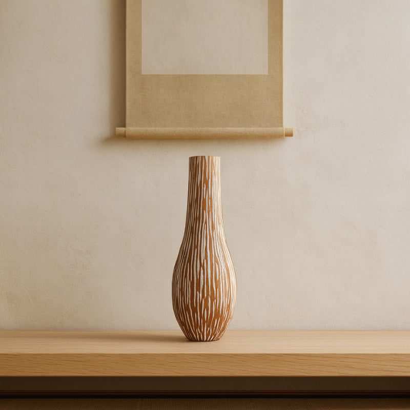 Wabi Sabi Wood Vase with a beige wall and framed artwork in the background