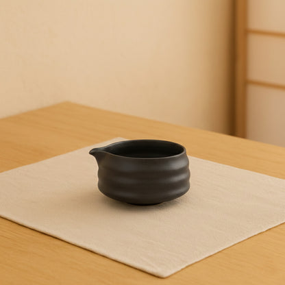 black matcha bowl on a beige background