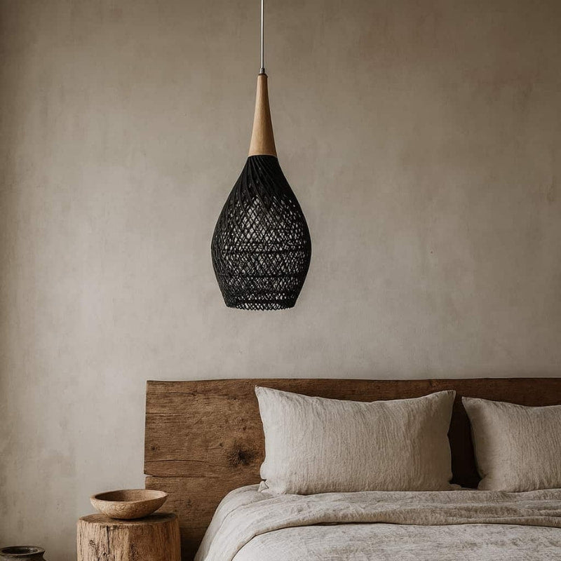 Bedroom with wooden headboard, beige bedding, and black wicker lights​.
