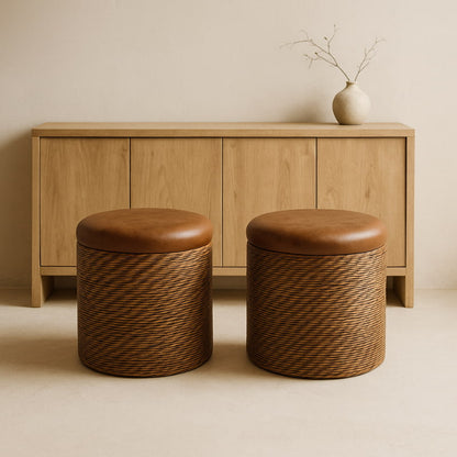 Two brown wicker ottoman​ in front of a wooden cabinet with a minimalistic background.