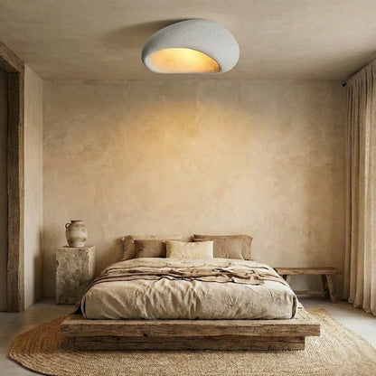 Bedroom with wooden bed, celling lamp nordic​, and textured walls.