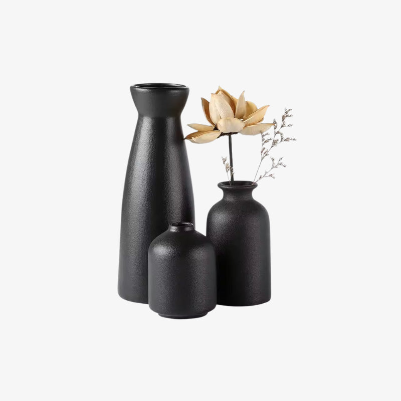 Set of three ceramic modern black vases​ on a white background
