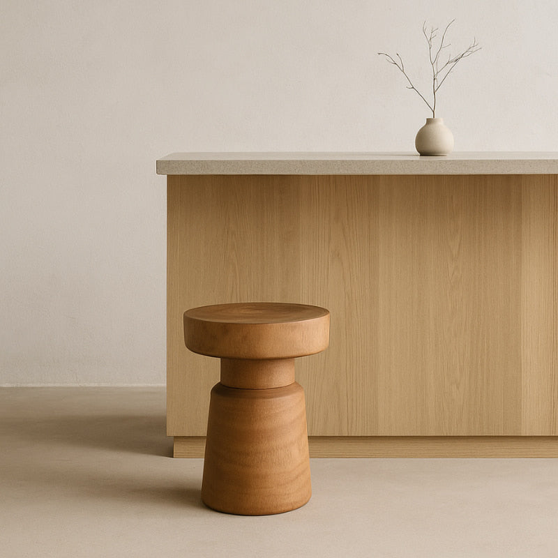 Wooden champagne cork stool in front of a wooden cabinet with a minimalistic design.
